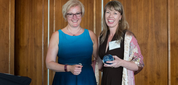 Laurie Dawkins (right) accepts Lighthouse Award from IABC BC chapter president Catherine Ducharme.